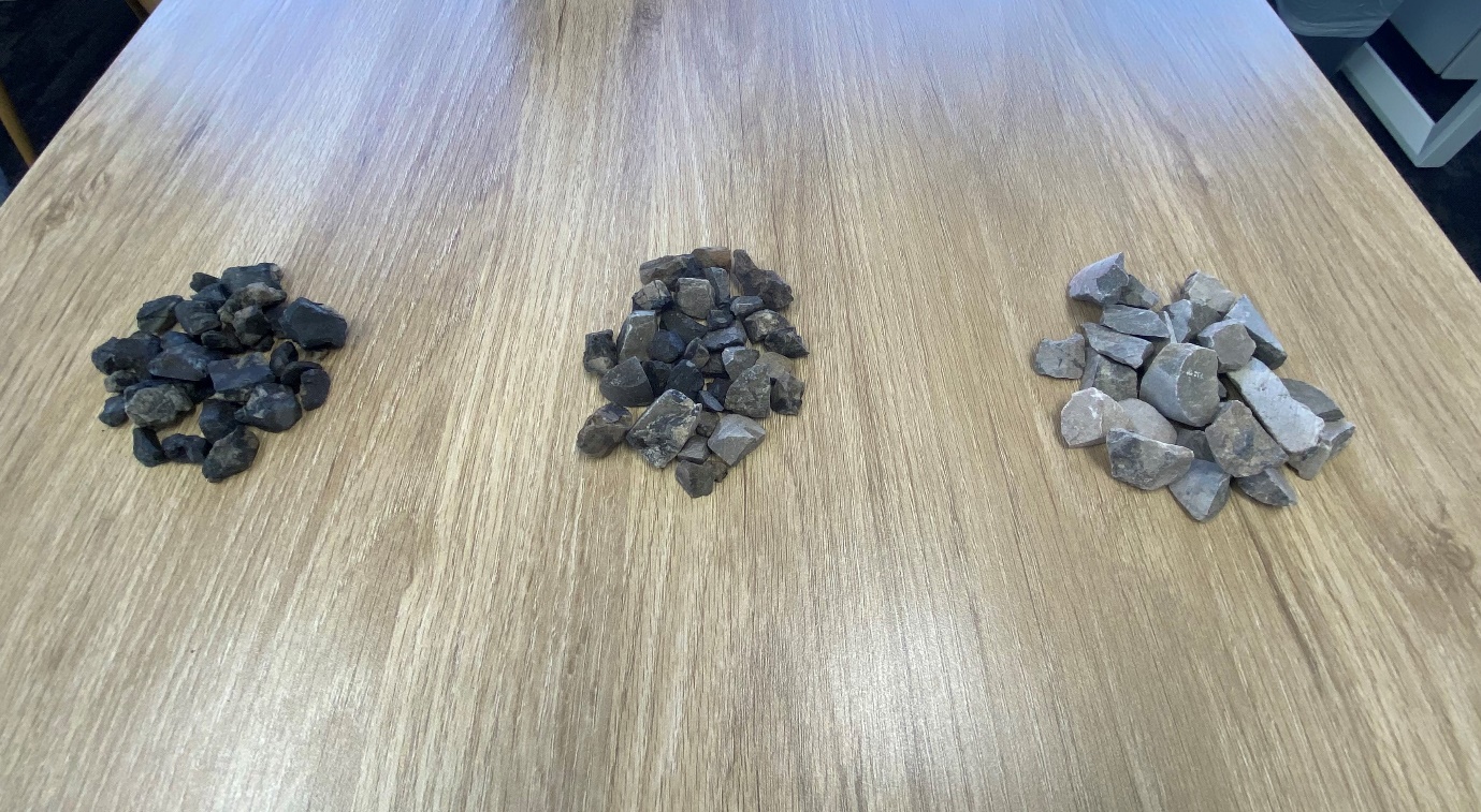 A group of small rocks on a wooden surfaceDescription automatically generated with low confidence