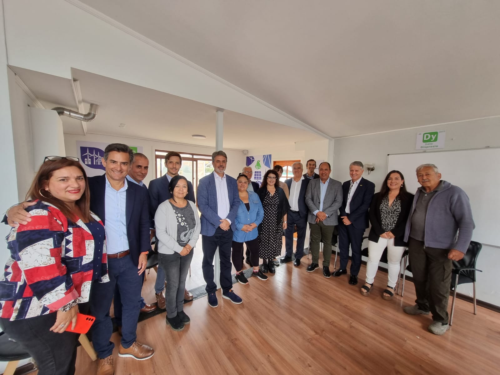 A group of people standing in a room
Description automatically generated