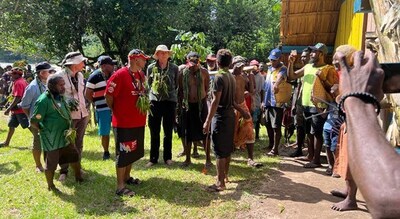 Figure 2: The Hon Walter Schnaubelt (red shirt) receives a traditional welcome at Nannum Village, Feni Island (CNW Group/Adyton Resources Corporation)
