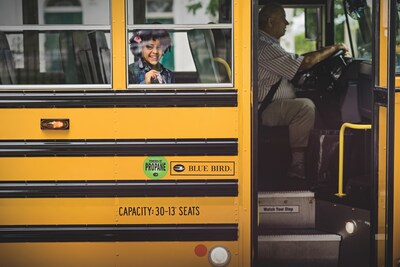 child riding in school bus powered by propane