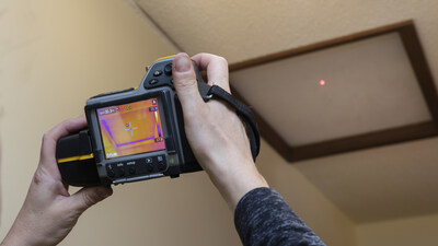 A thermal imaging camera, available for loan from many local libraries, is showing heat loss from an attic hatch, a common issue which can be addressed with draftpoofing. (CNW Group/FortisBC Energy Inc.)
