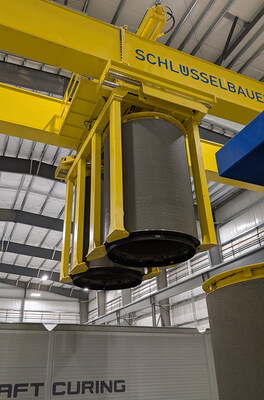 The Transexact Crane automatically moves pipe to the curing chambers.