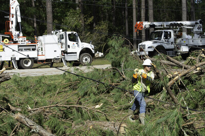 Georgia Power lineworker carries equipment to repair infrastructure that was damaged during Hurricane Helene. The storm resulted in more than 1,500 miles of downed power lines.