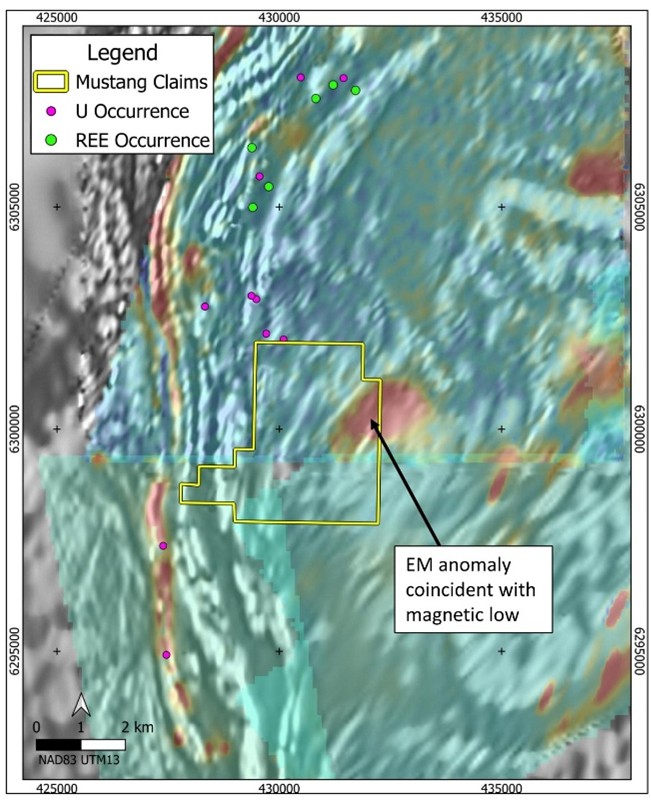 914W Project claim and mineral occurrences over a mosaic EM decay colour image from 3 adjacent airborne EM surveys where hot colours indicate electrical conductors, all overlying greyscale magnetic derivative background image. An EM conductor of interest is coincident with a magnetic-low anomaly and is considered to be a priority target area. (map layers retrieved from: Government of Saskatchewan Mining and Petroleum GeoAtlas and Natural Resources Canada)