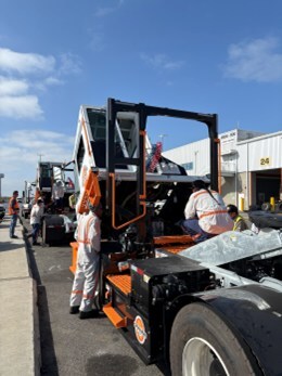 Hands-on training for new Orange EV trucks.