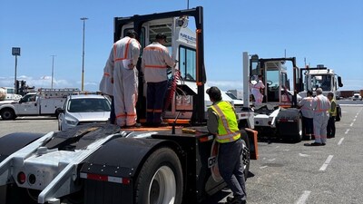 Orange EV technicians leading a training program that combines classroom instruction with real-world application for ILWU Local 13 union mechanics.