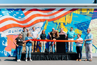 The American Crane & Equipment Corporation Team standing on stage for the ribbon cutting ceremony