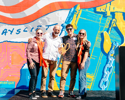 Karen Norheim, Mike Miller, Greg Didyoung and Stephanie Delibertis standing in front of the mural after the ribbon cutting