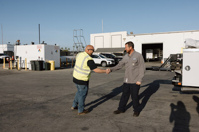 Duthie Power QA and Safety Coordinator Paul Lewis greets a Generator Technician in the Long Beach headquarters.