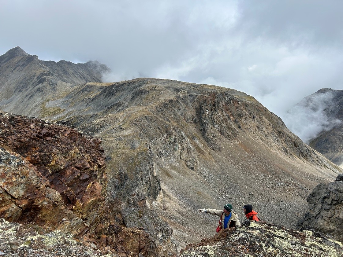 Geologist Len Gal is showing P.Geo Jean Paulter Cu mineralization at the Three Guardsman
