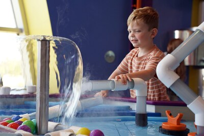Jace Tutoro explores the science of water and motion in one of Discovery Park of America’s interactive exhibits designed to inspire curiosity and hands-on learning.