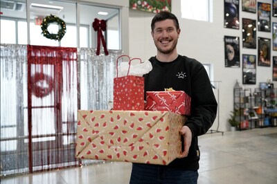 Everlight Solar staff member poses for a picture after wrapping gifts for local children.