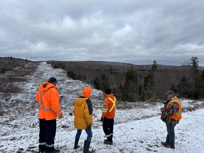 Workers look at snow-covered path where overhead transmission lines will be installed to link Nova Scotia and New Brunswick through a second energy connection. (CNW Group/Canada Infrastructure Bank)