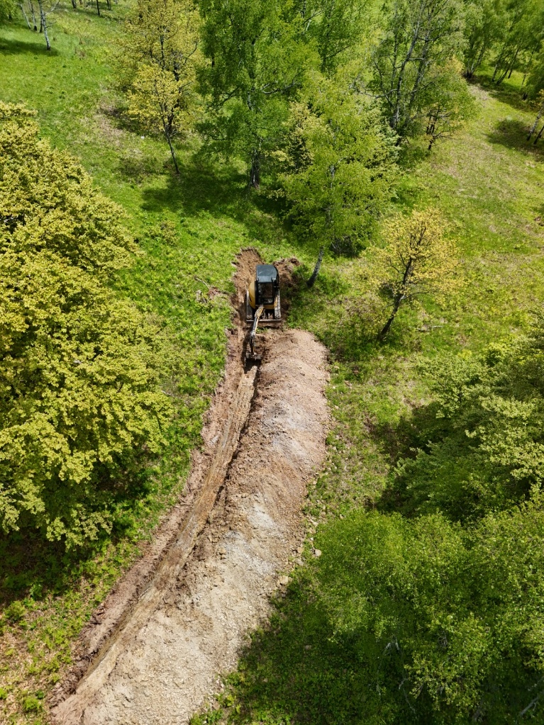 Figure 4: Mechanical trenching under way during the 2025 field season at the Vrela-Kremin trend.