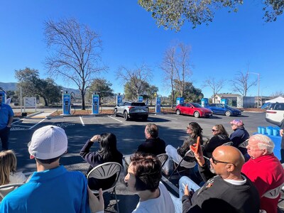 Ribbon cutting ceremony with local EV drivers and business owners
