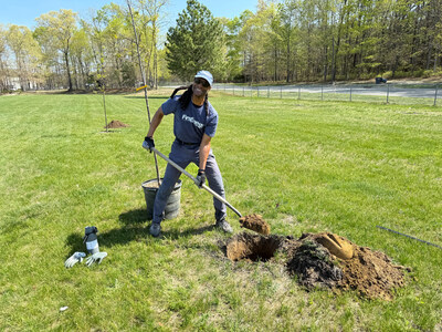FirstEnergy's Oscar Johnson, Jr. plants a tree at Howell Middle School South in Howell, N.J. as part of a tree planting event.