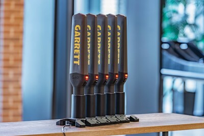 Five Garrett Guides charging in sequence while mounted on charging bases.