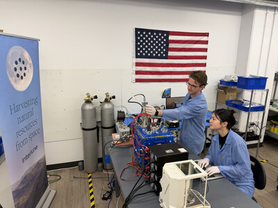 Interlune test engineer Alex Lewandowski (left) and mechanical engineer Jessica Wu (right) check test equipment for the mass spectrometer system in the Regolith Lab at the company’s Seattle headquarters