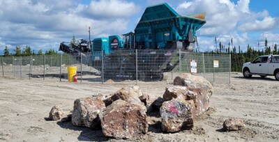 Figure 3: Spodumene pegmatite boulders ready for crusher located proximal to Camp Shaakichiuwaanaan. (CNW Group/PMET Resources Inc.)
