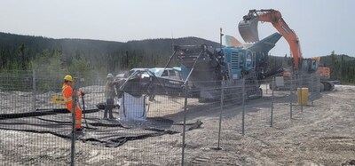 Figure 4: Crushing of spodumene pegmatite boulders into bulk bags. (CNW Group/PMET Resources Inc.)