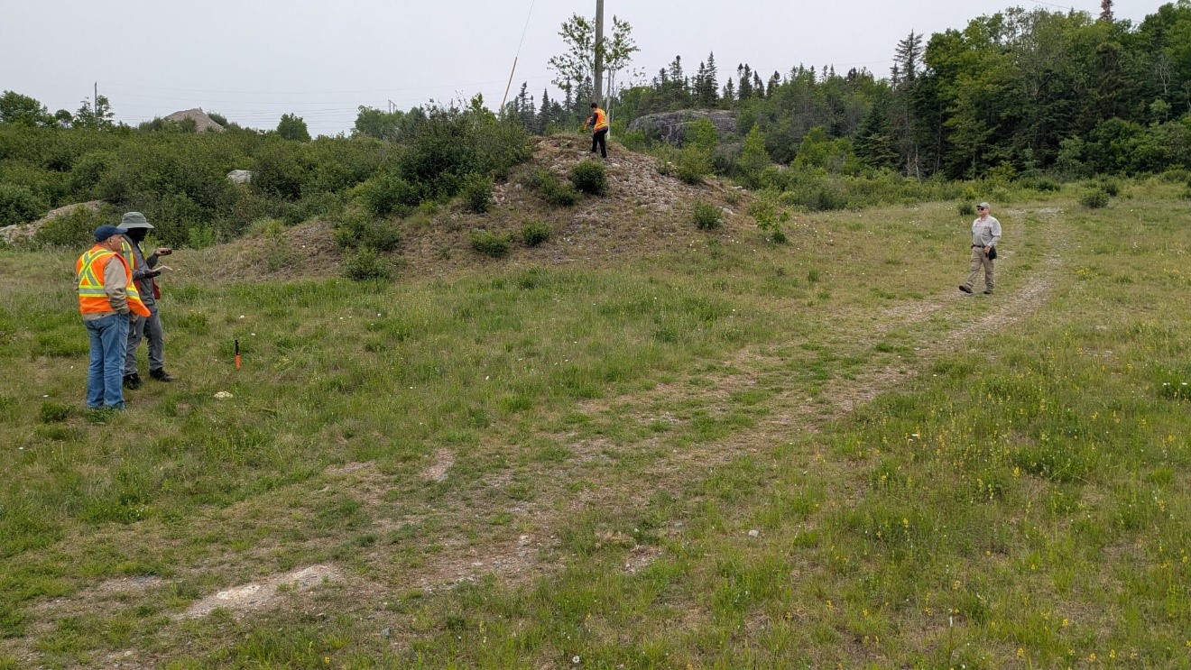 Figure 2- AIS team locating drill holes