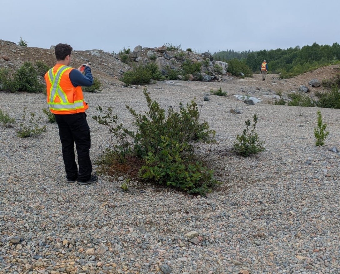 Figure 3- AIS team locating drill holes