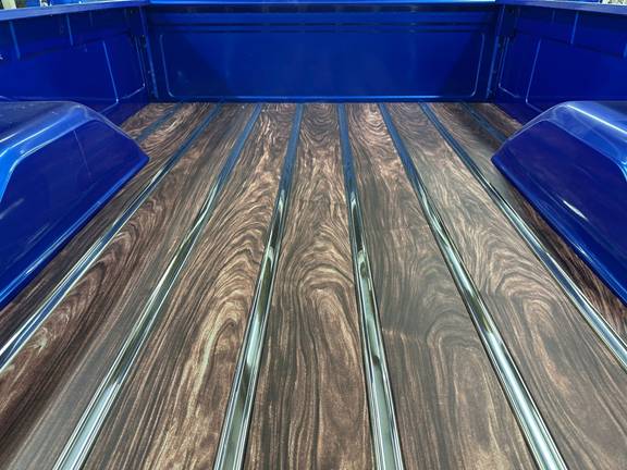 Straight-on view of the wood-grain aluminum bed floor boards