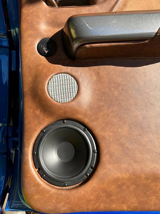 Speakers in a brown leather door panel